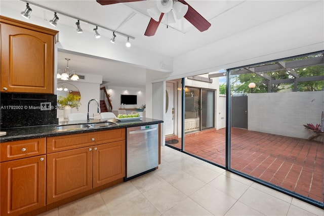 4730 SW 67th Ave Unit I1, Miami, FL 33155 - kitchen with stainless steel dishwasher, a sink, brown cabinets, tasteful backsplash, and a ceiling fan