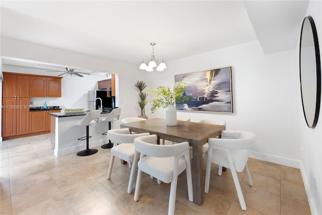 4730 SW 67th Ave Unit I1, Miami, FL 33155 - dining area featuring light tile patterned floors, a chandelier, a ceiling fan, and baseboards