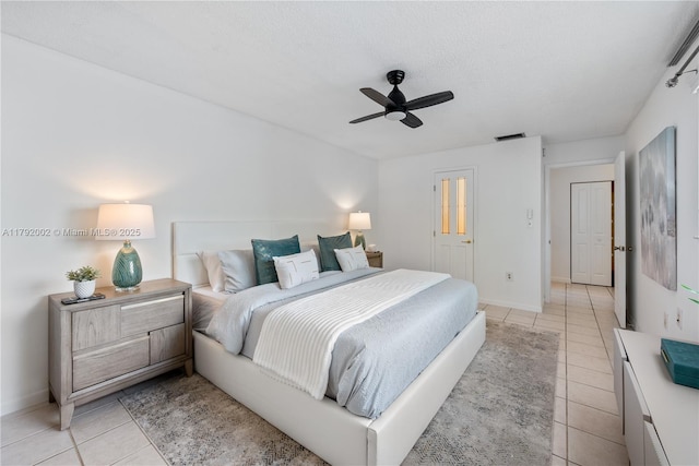 4730 SW 67th Ave Unit I1, Miami, FL 33155 - bedroom with light tile patterned flooring, ceiling fan, baseboards, and a textured ceiling