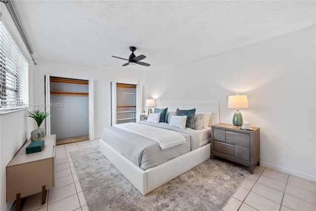 4730 SW 67th Ave Unit I1, Miami, FL 33155 - bedroom featuring tile patterned floors, a textured ceiling, ceiling fan, and baseboards