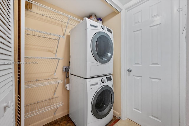 4730 SW 67th Ave Unit I1, Miami, FL 33155 - laundry area with stacked washer and clothes dryer and baseboards