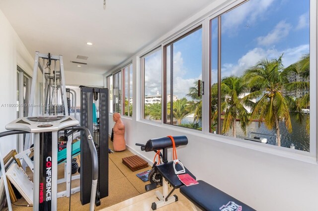 418 Tammarind Dr, Hallandale Beach, FL 33009 - exercise room featuring recessed lighting, a water view, and baseboards