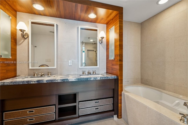 6799 Collins Ave Unit 1602, Miami Beach, FL 33141 - full bath featuring a bath, tile walls, and double vanity