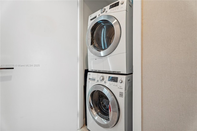 6799 Collins Ave Unit 1602, Miami Beach, FL 33141 - washroom with stacked washer and clothes dryer