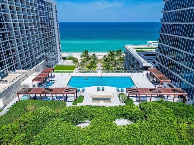6799 Collins Ave Unit 1602, Miami Beach, FL 33141 - community pool featuring a water view, a patio, and a hot tub