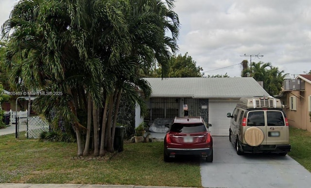 328 SE 2nd Ave, Dania Beach, FL 33004 - view of front of home with an attached garage, driveway, and a front yard