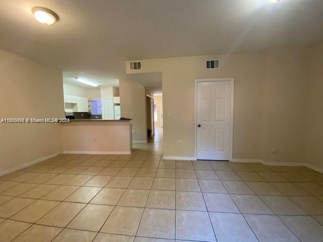646 SW 7th Ter, Florida City, FL 33034 - empty room with light tile patterned floors and baseboards