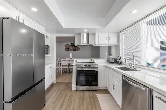 7450 Branch St, Hollywood, FL 33024 - kitchen featuring stainless steel appliances, wall chimney exhaust hood, a sink, light countertops, and white cabinets
