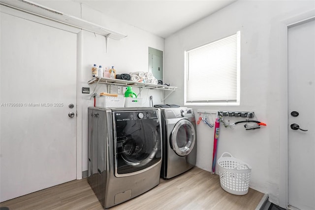 7450 Branch St, Hollywood, FL 33024 - laundry area featuring washing machine and clothes dryer, light wood-style floors, and electric panel