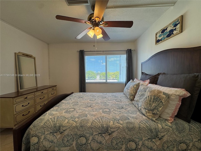 bedroom featuring a textured ceiling and a ceiling fan