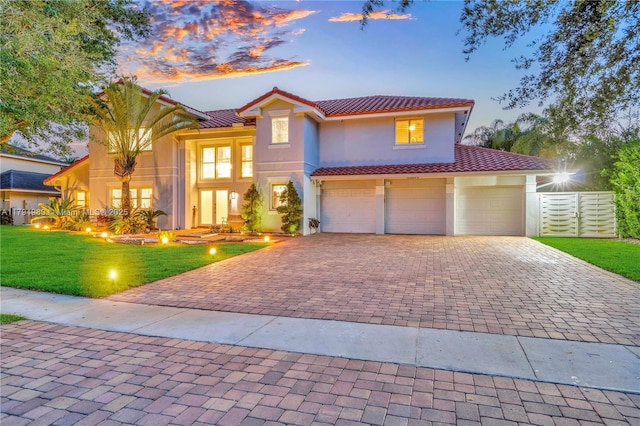 20230 NW 7th St, Pembroke Pines, FL 33029 - mediterranean / spanish-style house with a tiled roof, decorative driveway, stucco siding, and a front lawn
