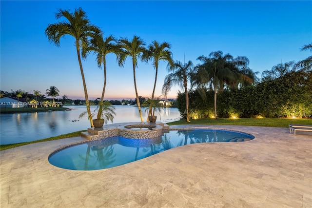 20230 NW 7th St, Pembroke Pines, FL 33029 - pool at dusk featuring a patio area, a water view, and a pool with connected hot tub