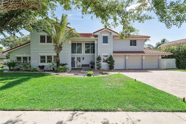 20230 NW 7th St, Pembroke Pines, FL 33029 - mediterranean / spanish-style home featuring driveway, a front lawn, french doors, stucco siding, and a tile roof