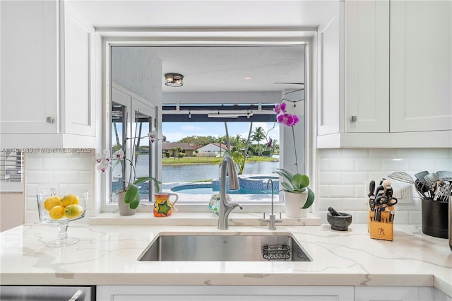 20230 NW 7th St, Pembroke Pines, FL 33029 - kitchen featuring a sink, white cabinetry, tasteful backsplash, and light stone counters