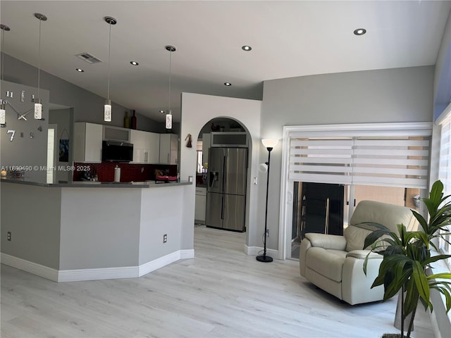 14530 SW 123rd Ct, Miami, FL 33186 - kitchen with refrigerator with ice dispenser, light wood-type flooring, stainless steel microwave, decorative backsplash, and lofted ceiling