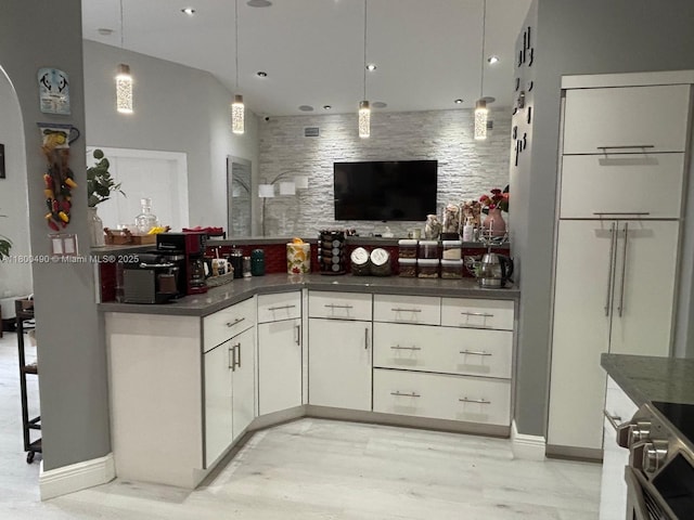 14530 SW 123rd Ct, Miami, FL 33186 - kitchen featuring arched walkways, dark countertops, hanging light fixtures, and stainless steel range oven