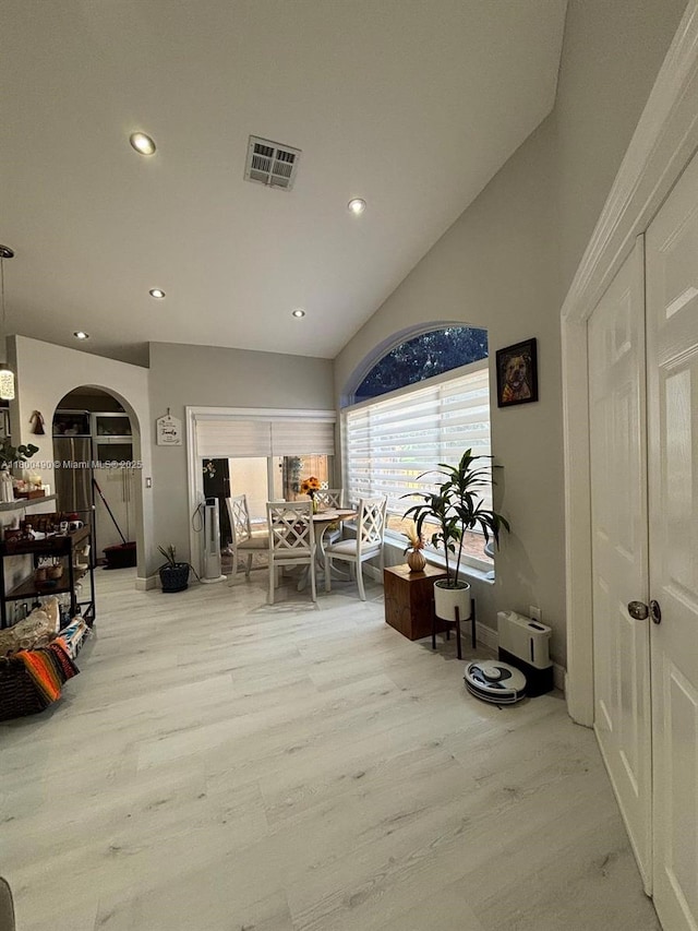 14530 SW 123rd Ct, Miami, FL 33186 - dining space with light wood-style flooring, arched walkways, recessed lighting, and vaulted ceiling