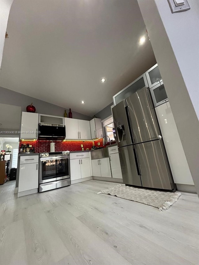 14530 SW 123rd Ct, Miami, FL 33186 - kitchen with appliances with stainless steel finishes, tasteful backsplash, white cabinetry, dark countertops, and lofted ceiling