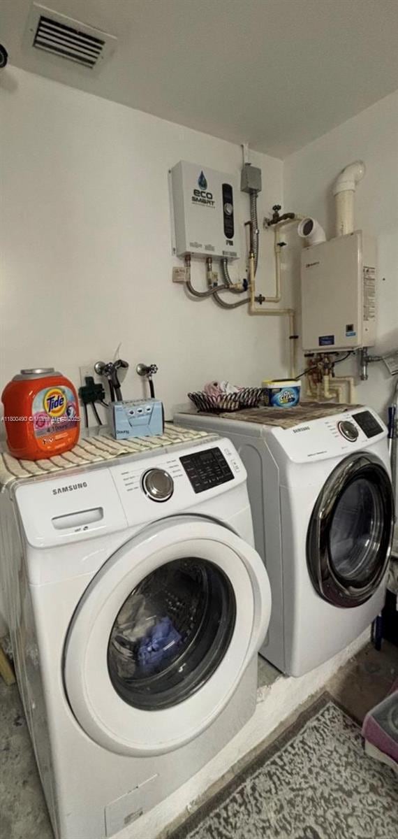 14530 SW 123rd Ct, Miami, FL 33186 - washroom featuring washing machine and clothes dryer and tankless water heater