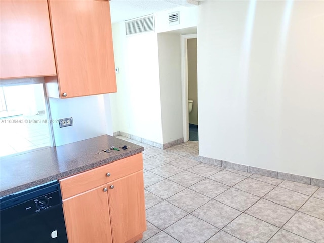 3703 NE 166th St Unit 704, North Miami Beach, FL 33160 - kitchen featuring dishwasher, light tile patterned floors, baseboards, dark countertops, and light brown cabinets