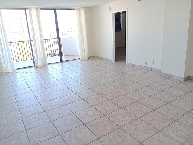 3703 NE 166th St Unit 704, North Miami Beach, FL 33160 - unfurnished room with light tile patterned floors and baseboards