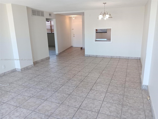 3703 NE 166th St Unit 704, North Miami Beach, FL 33160 - empty room featuring a chandelier, baseboards, and light tile patterned floors