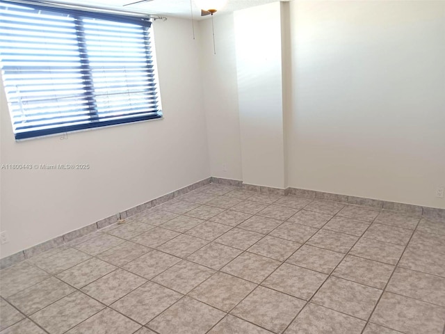 3703 NE 166th St Unit 704, North Miami Beach, FL 33160 - spare room featuring light tile patterned floors and baseboards