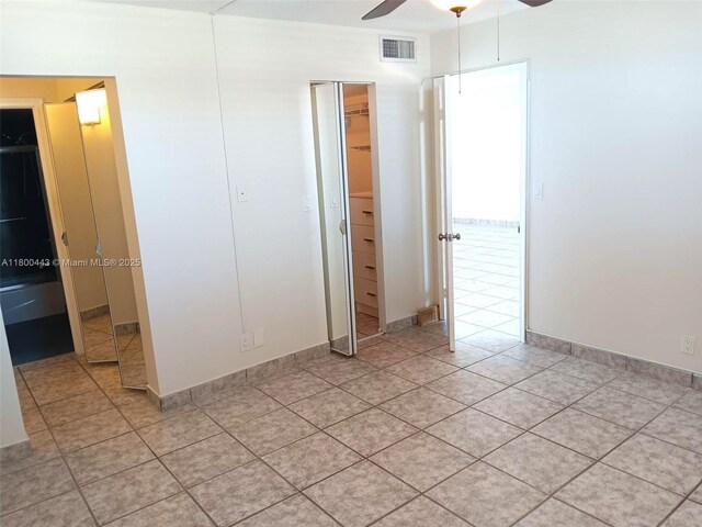 3703 NE 166th St Unit 704, North Miami Beach, FL 33160 - unfurnished bedroom with light tile patterned floors, a ceiling fan, a closet, and baseboards