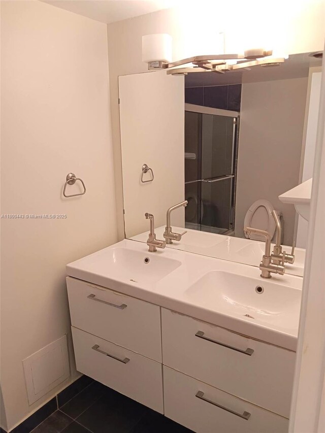 3703 NE 166th St Unit 704, North Miami Beach, FL 33160 - bathroom featuring a shower stall, double vanity, and tile patterned flooring