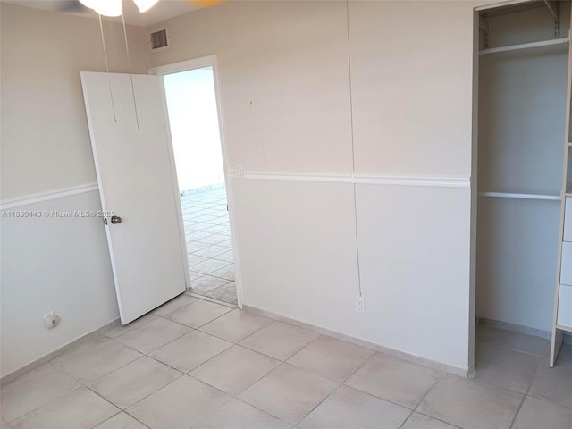 3703 NE 166th St Unit 704, North Miami Beach, FL 33160 - unfurnished bedroom featuring light tile patterned floors and a closet