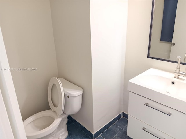 3703 NE 166th St Unit 704, North Miami Beach, FL 33160 - half bathroom with toilet, vanity, tile patterned floors, and baseboards