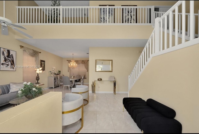 7600 Belmonte Blvd, Margate, FL 33063 - living area with a chandelier, light tile patterned floors, a ceiling fan, stairs, and a towering ceiling
