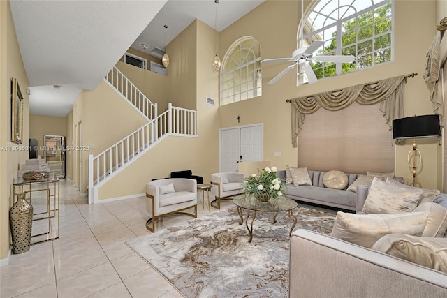 7600 Belmonte Blvd, Margate, FL 33063 - living area featuring stairs, a ceiling fan, light tile patterned flooring, baseboards, and a towering ceiling