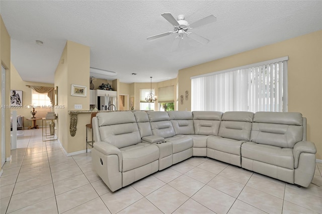 7600 Belmonte Blvd, Margate, FL 33063 - living area featuring light tile patterned flooring, a ceiling fan, a chandelier, baseboards, and a textured ceiling