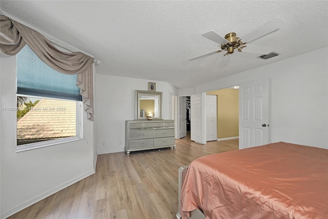 7600 Belmonte Blvd, Margate, FL 33063 - bedroom with light wood-type flooring, a textured ceiling, baseboards, and a ceiling fan