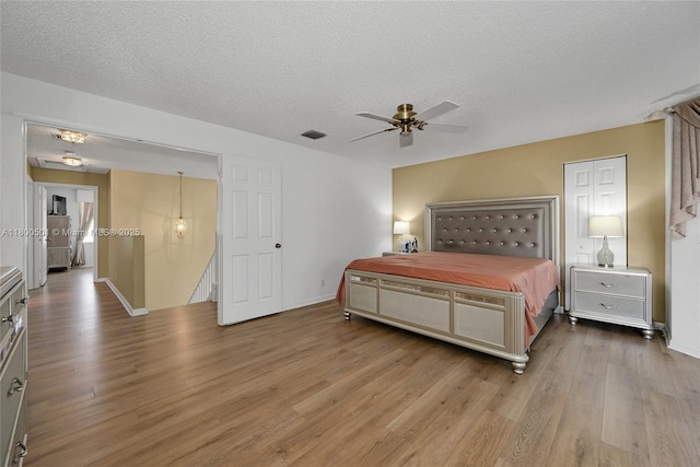 7600 Belmonte Blvd, Margate, FL 33063 - bedroom with light wood finished floors, a textured ceiling, a ceiling fan, and baseboards