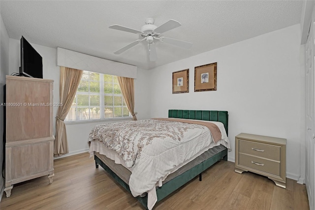 7600 Belmonte Blvd, Margate, FL 33063 - bedroom with wood finished floors, a textured ceiling, baseboards, and a ceiling fan