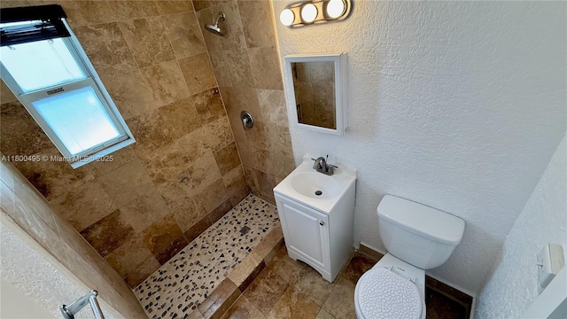 7334 Harding Ave Unit 3, Miami Beach, FL 33141 - bathroom with a tile shower, toilet, vanity, and a textured wall