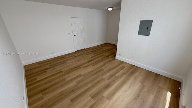 7334 Harding Ave Unit 3, Miami Beach, FL 33141 - spare room featuring electric panel, baseboards, and wood finished floors