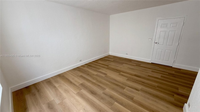 7334 Harding Ave Unit 3, Miami Beach, FL 33141 - spare room featuring baseboards and light wood-style flooring