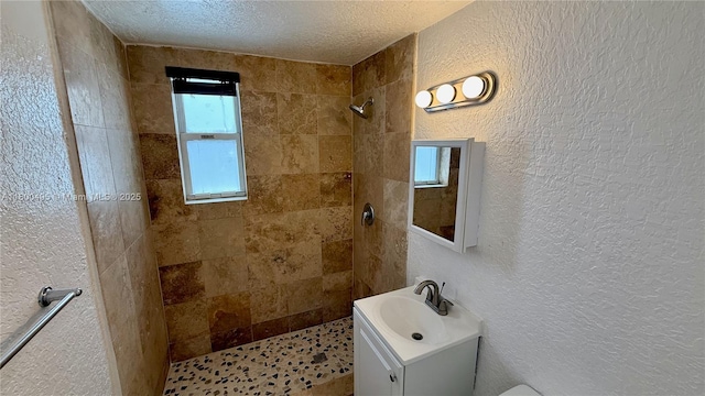 7334 Harding Ave Unit 3, Miami Beach, FL 33141 - full bathroom featuring a tile shower, a textured wall, vanity, and a textured ceiling
