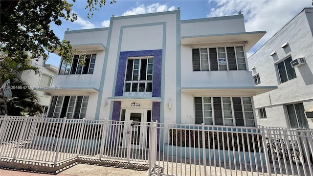 7334 Harding Ave Unit 3, Miami Beach, FL 33141 - view of front of home with stucco siding, fence, and an AC wall unit