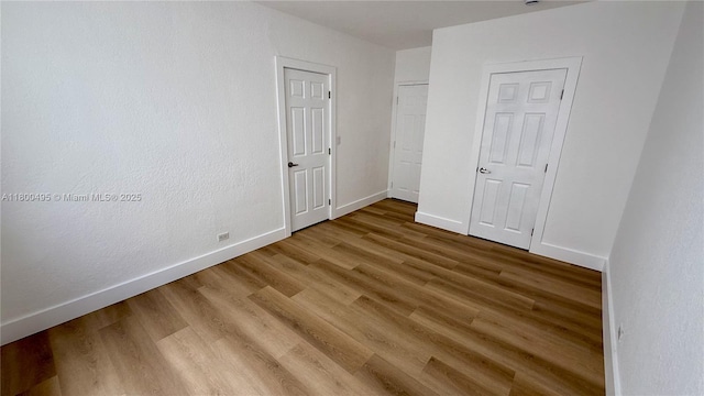 7334 Harding Ave Unit 3, Miami Beach, FL 33141 - unfurnished bedroom featuring baseboards and wood finished floors