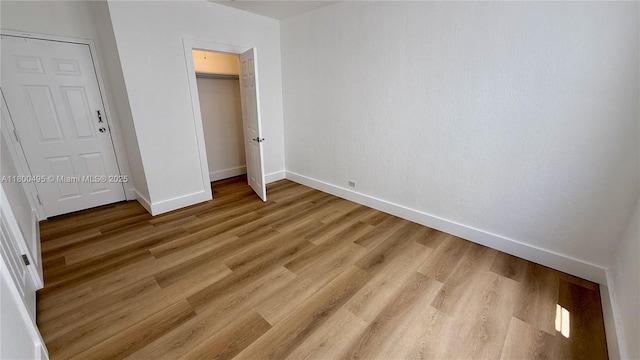 7334 Harding Ave Unit 3, Miami Beach, FL 33141 - unfurnished bedroom with baseboards, light wood finished floors, and a closet