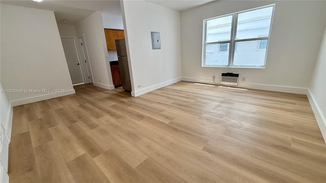 7334 Harding Ave Unit 3, Miami Beach, FL 33141 - spare room featuring electric panel, light wood-style flooring, baseboards, and heating unit