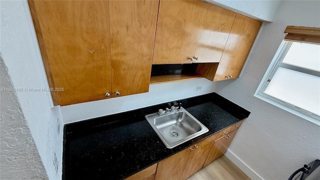 7334 Harding Ave Unit 3, Miami Beach, FL 33141 - kitchen with a sink, a textured wall, dark countertops, and baseboards
