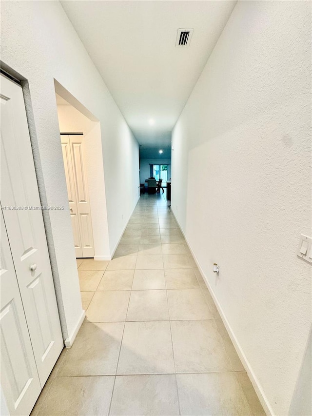hallway with light tile patterned floors