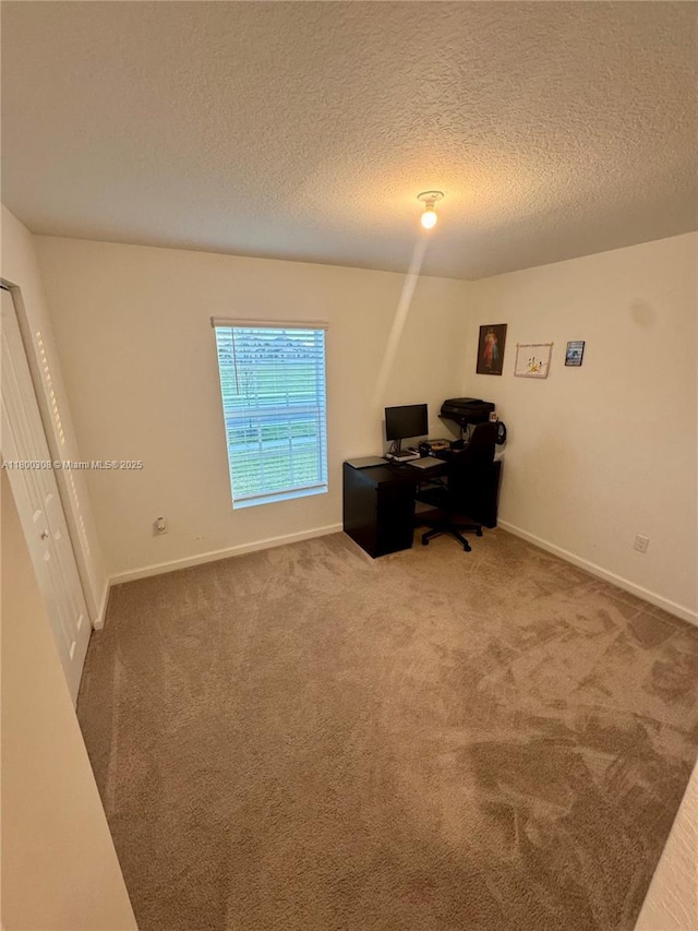 office featuring carpet, a textured ceiling, and baseboards