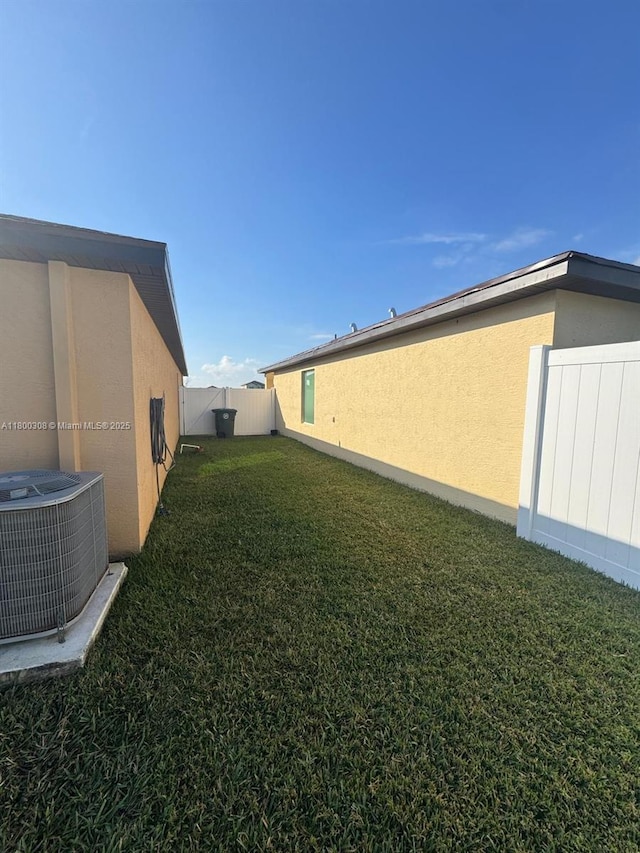 view of yard featuring central air condition unit