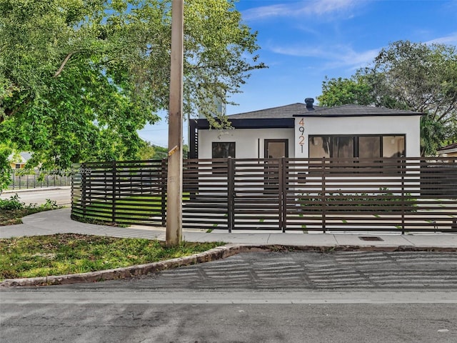 4921 NW 6th Ave, Miami, FL 33127 - view of front of home with stucco siding and a fenced front yard